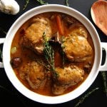 Coq au vin blanc in a white dish