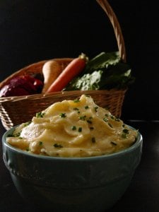 Instant Pot Mashed Potatoes and Parsnips in a turquoise bowl with basket of fresh vegetables in the background - Paint the Kitchen Red