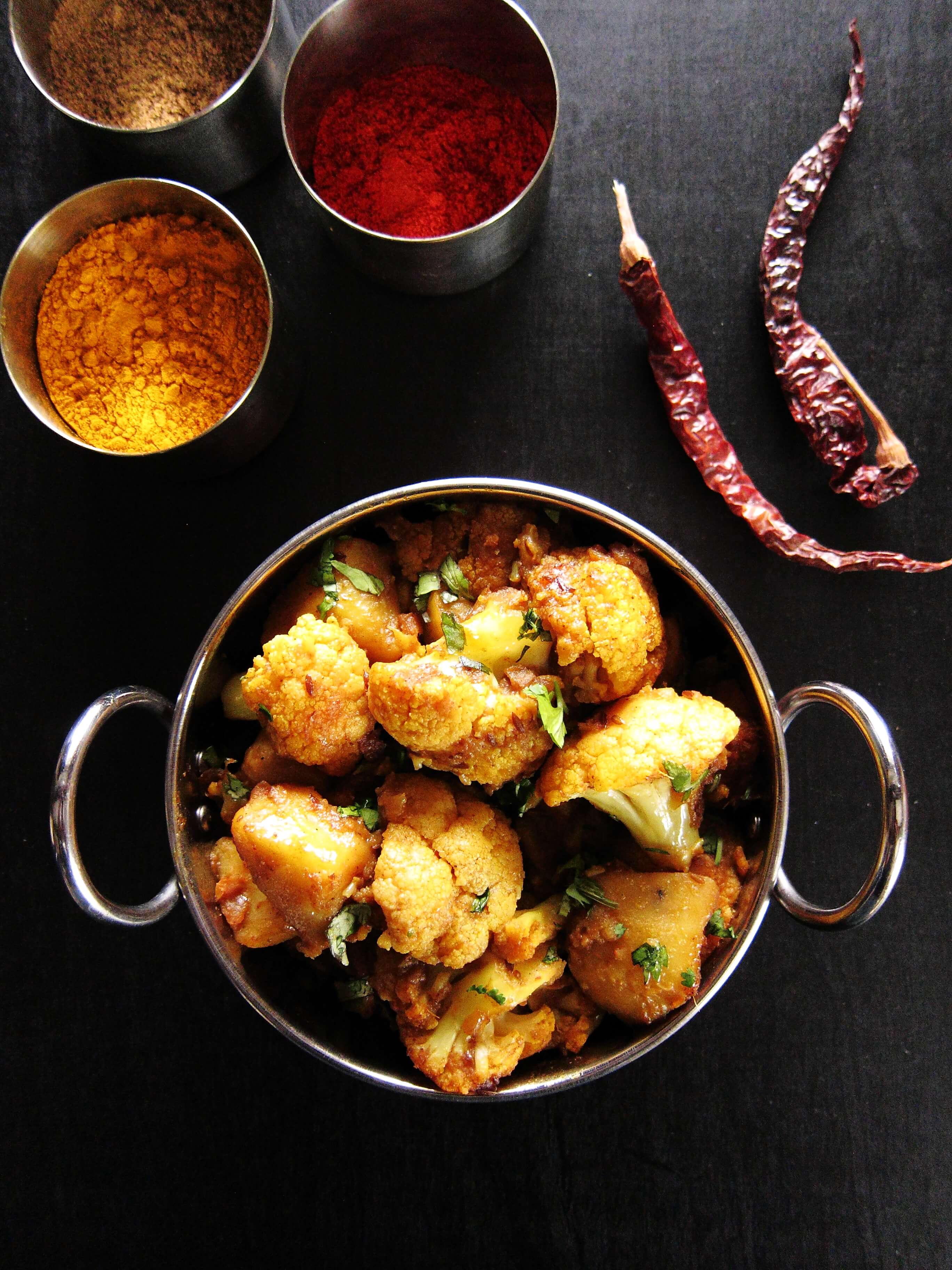 Instant Pot Aloo Gobi | Indian Cauliflower with Potatoes in a bowl with spices in background