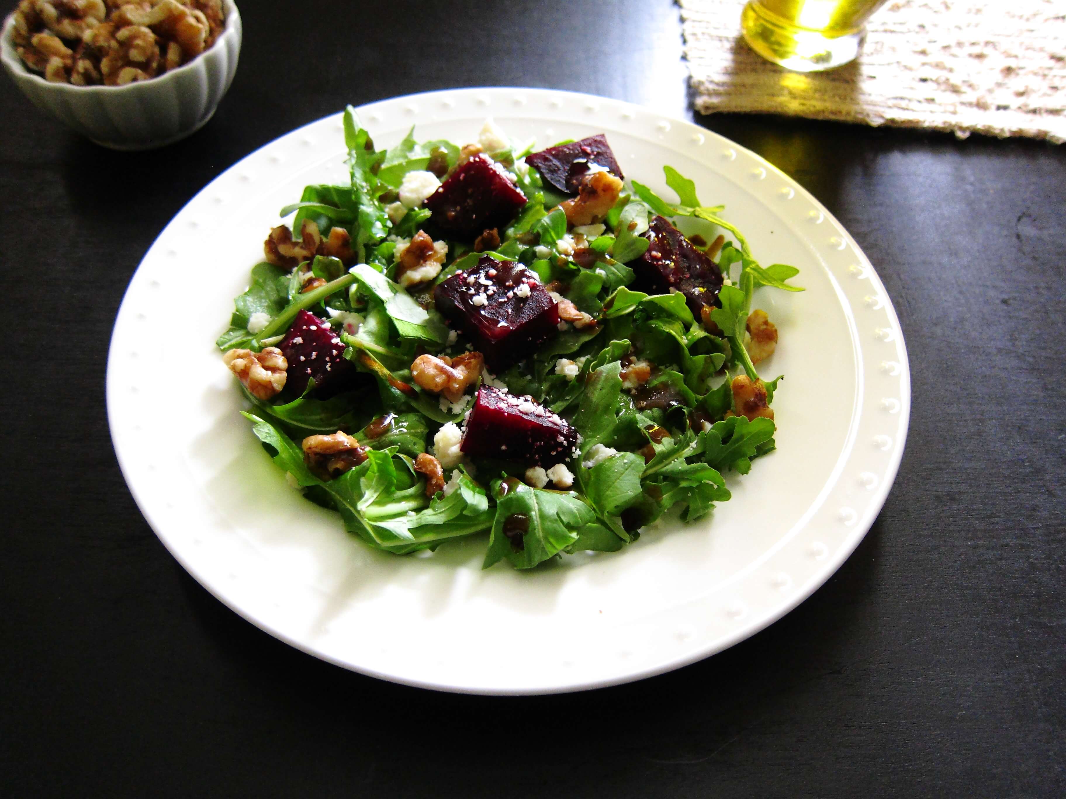 Instant Pot Beet Salad with arugula, goat cheese and walnuts on a white plate