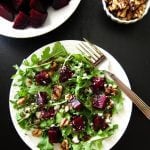 Instant Pot Beet Salad on white plate with beets and walnuts on black background