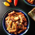 Instant Pot vegetarian pasta in blue and green bowl with sauce and shredded cheese