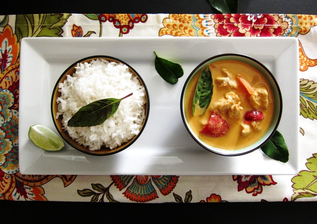 Instant Pot Pot in Pot Thai Curry and Rice in separate bowls on white serving dish over flowery placemat - Paint the Kitchen Red