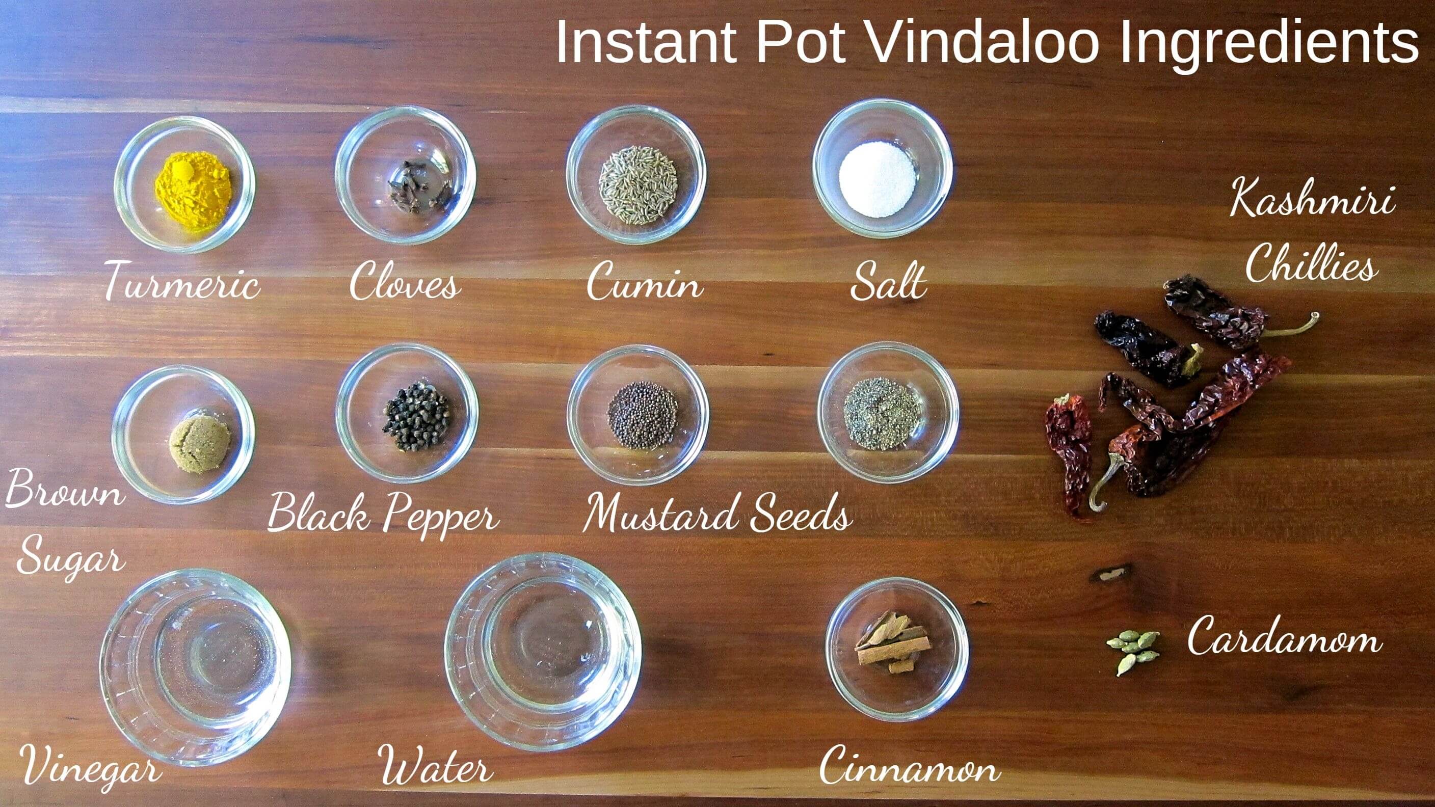 Instant Pot Vindaloo Ingredients  - turmeric, cloves, cumin, salt, Kashmiri chilis, brown sugar, black pepper, mustard seeds, vinegar, water, cinnamon, cardamom