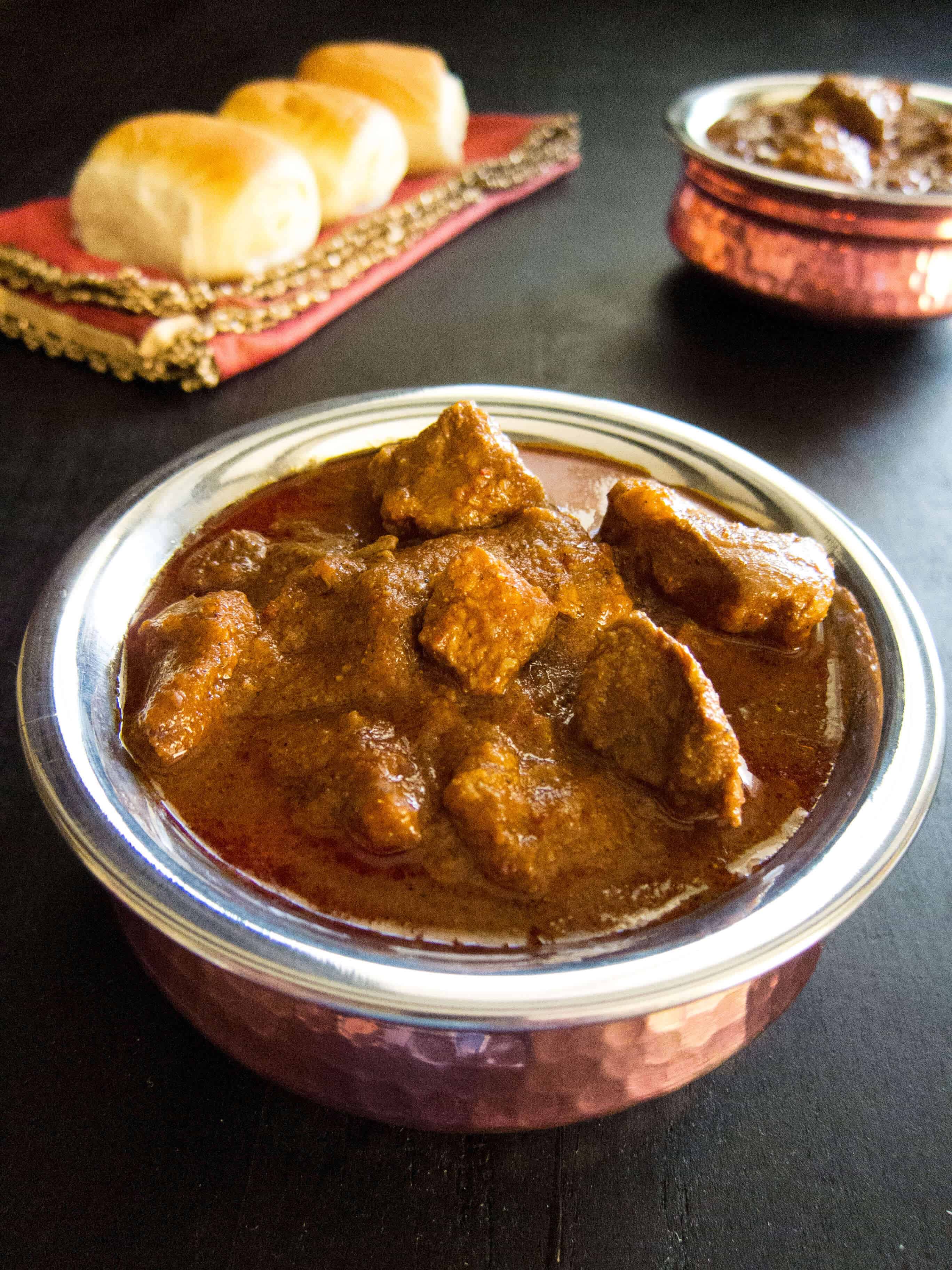 Instant Pot Vindaloo in a copper bowl with bread in the background - Paint the Kitchen Red