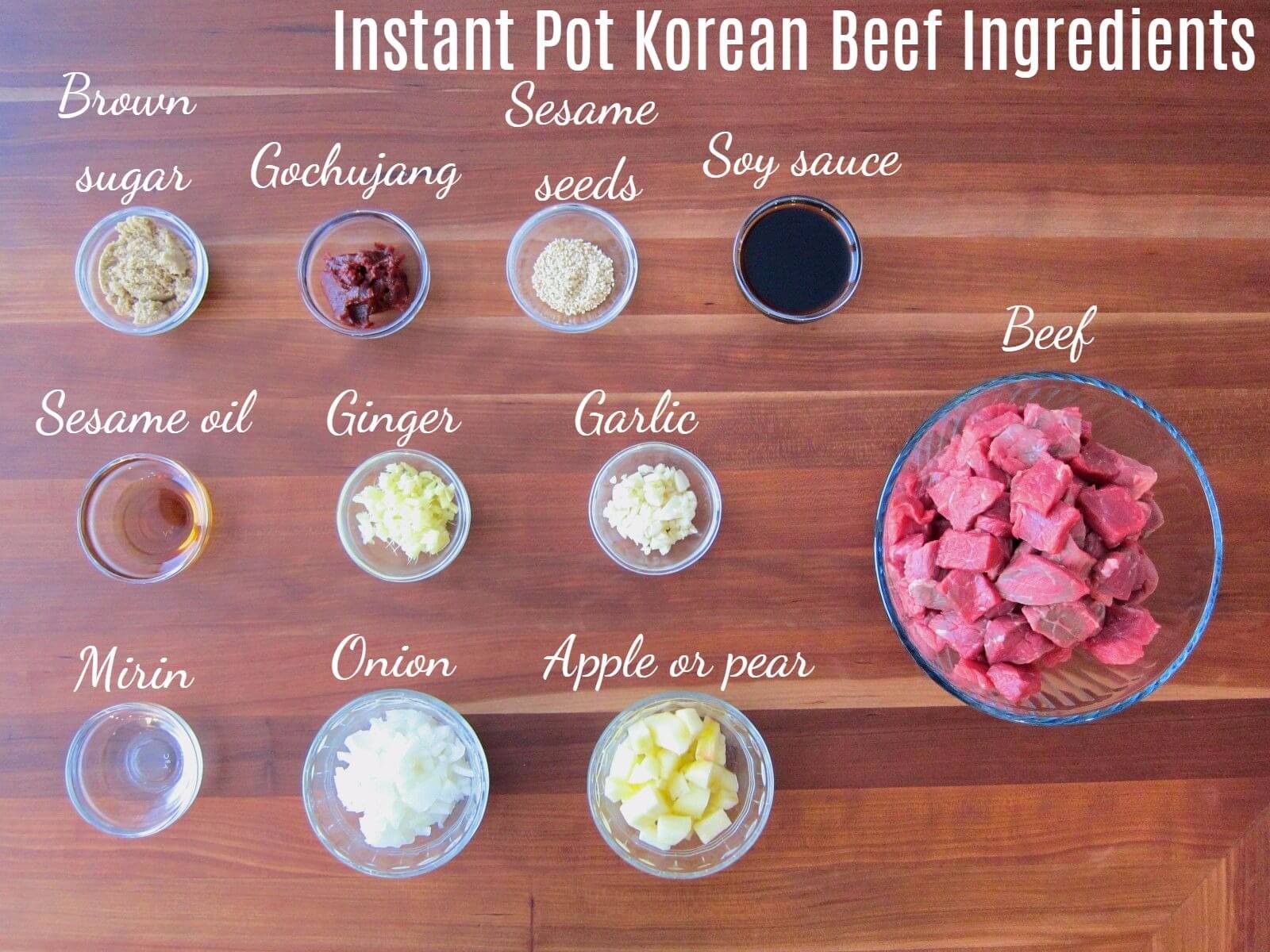 Instant Pot Korean Beef Ingredients - brown sugar, gochujang, sesame seeds, soy sauce, sesame oil, ginger, garlic, mirin, onion, apple, beef