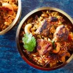 Instant Pot Biryani with Lamb landscape with 2 brass bowls on blue table - Paint the Kitchen Red