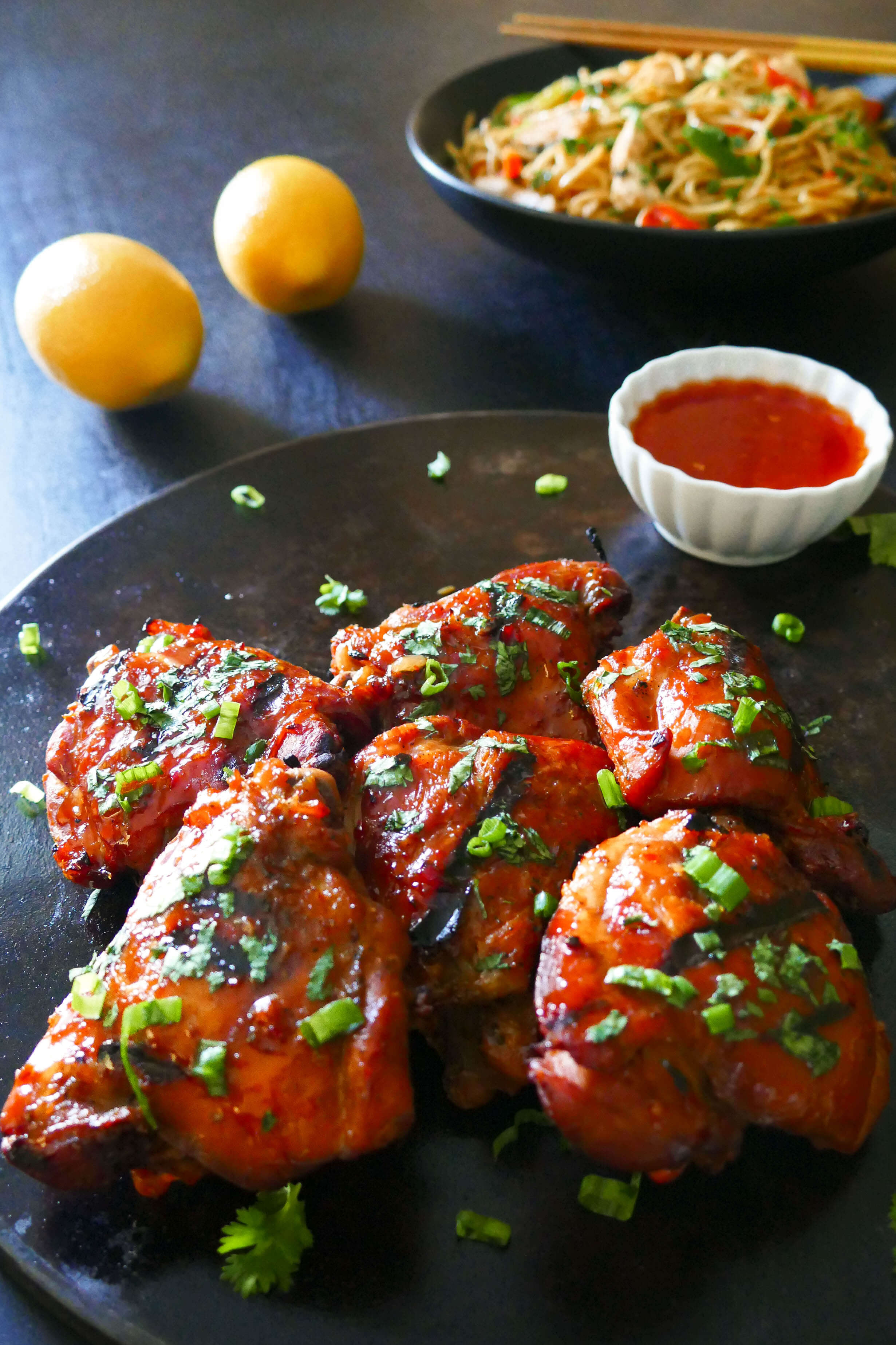Instant Pot Thai Grilled Chicken Thighs on dark background with sprinkled cilantro and green onions
