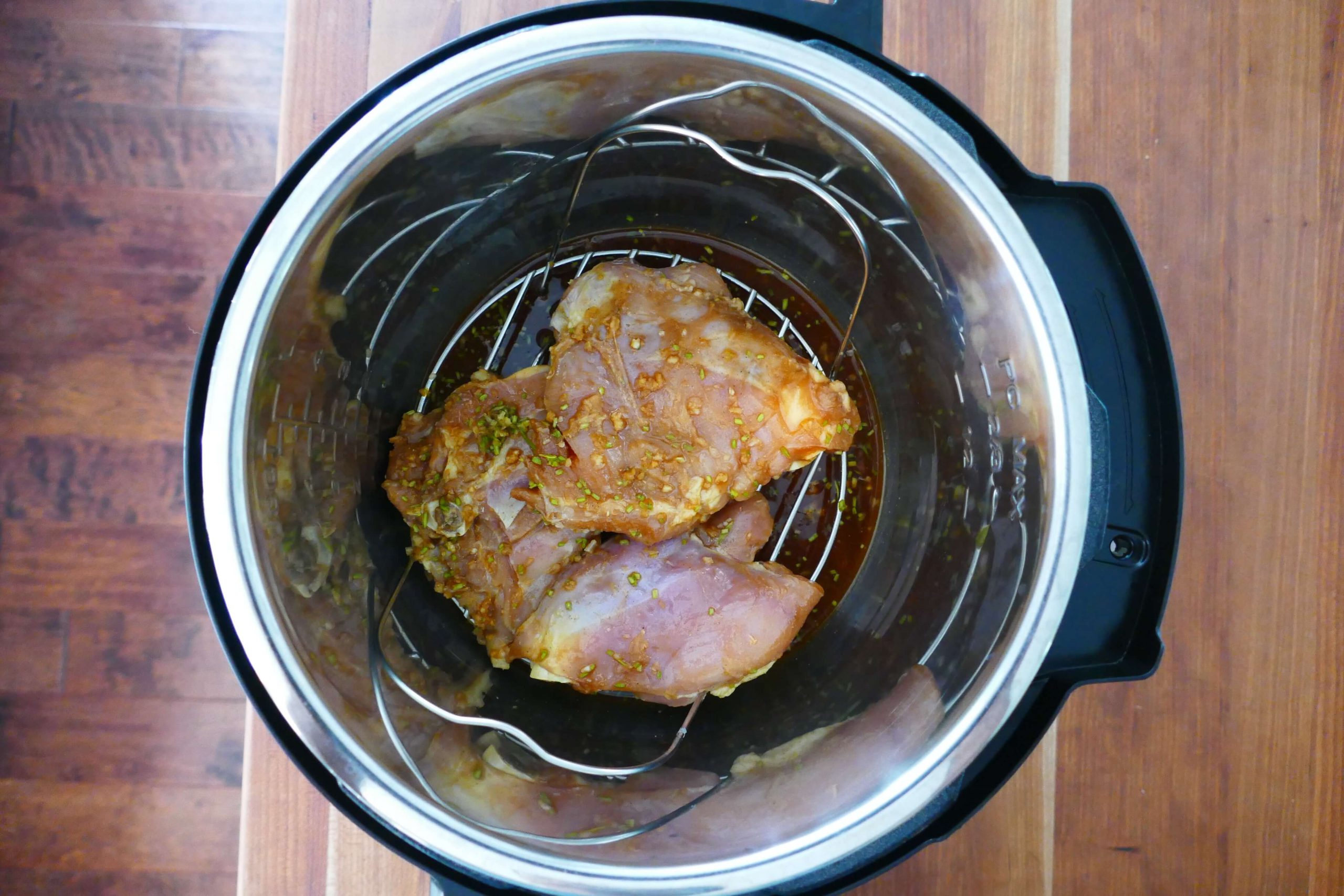 Three pieces of Instant Pot Chicken on Trivet -Paint the Kitchen Red