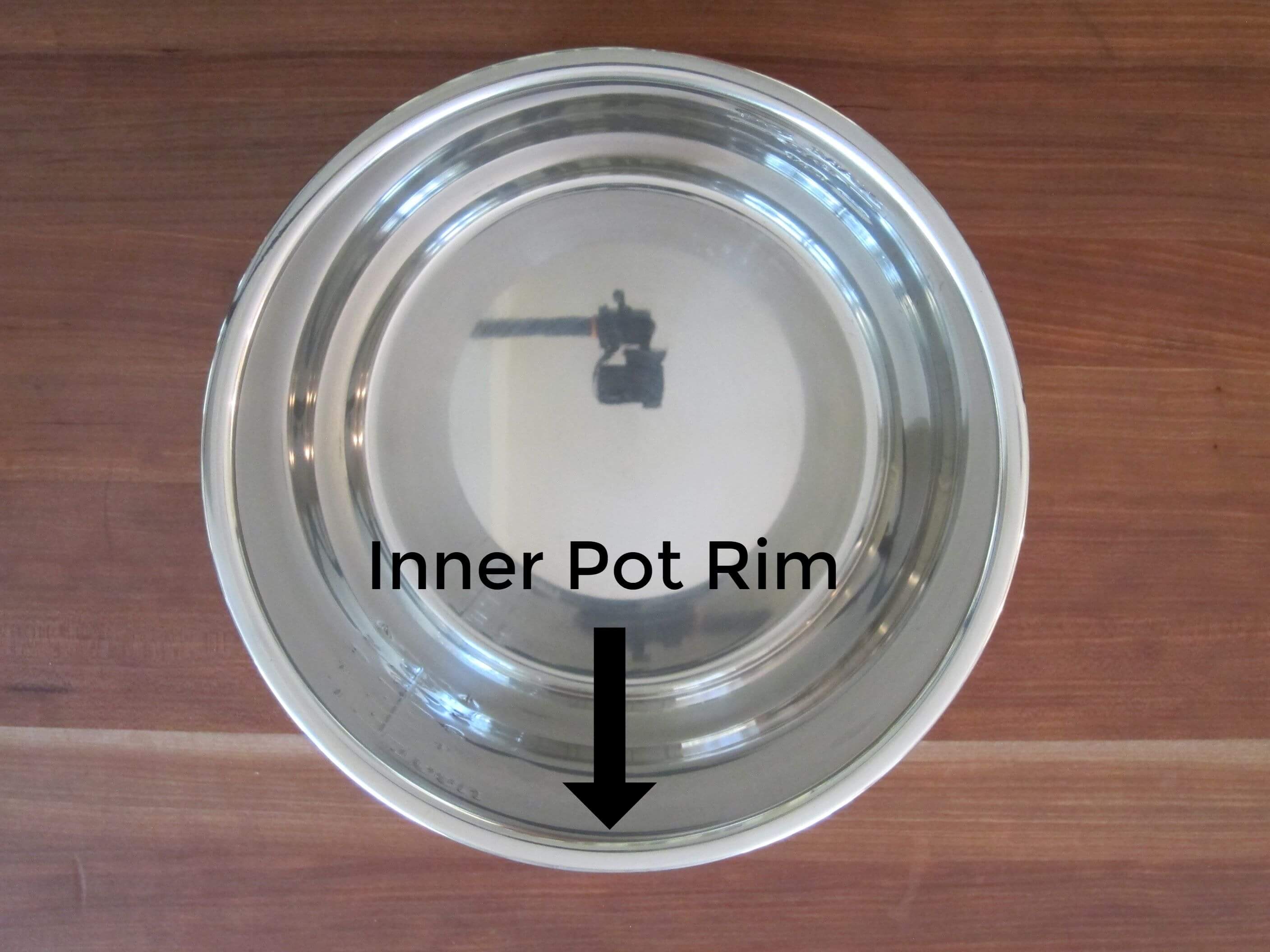 Instant Pot Inner Pot with arrow pointing to the rim