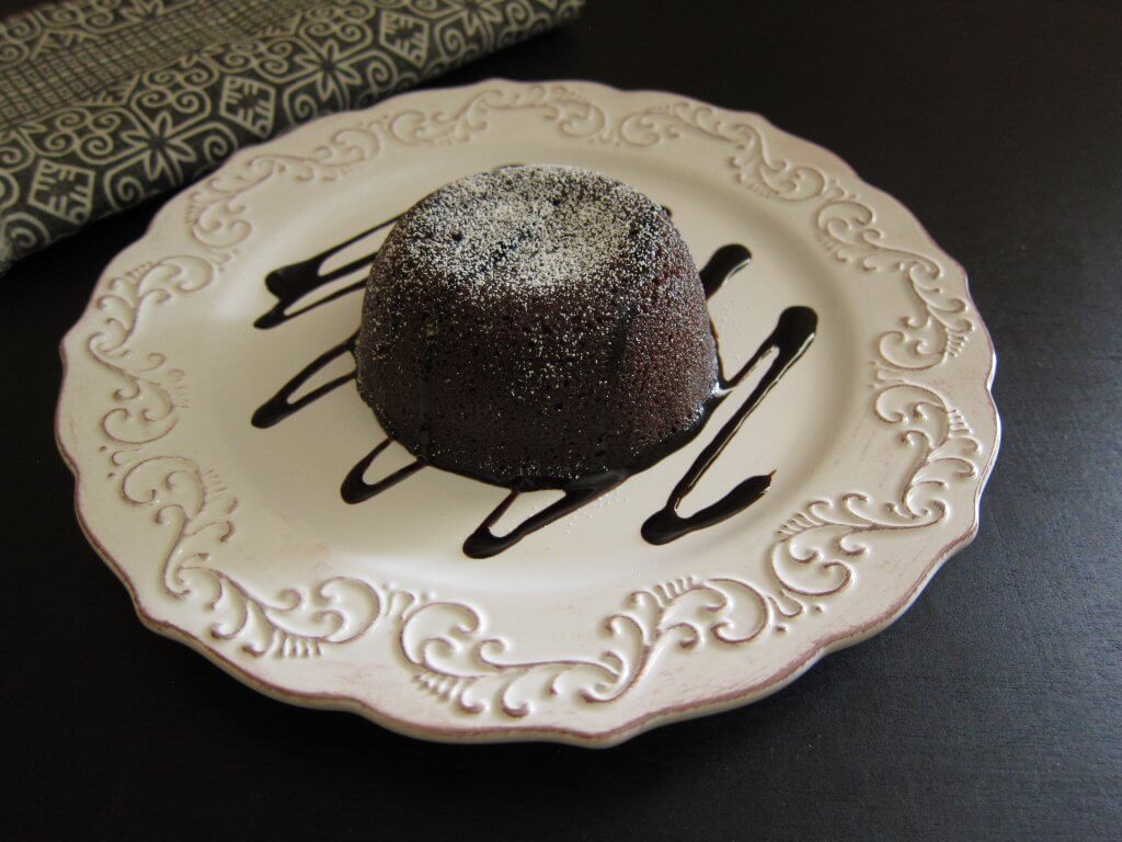 Instant Pot Lava Cake on plate turned out of baking dish, with powdered sugar on top - Paint the Kitchen Red