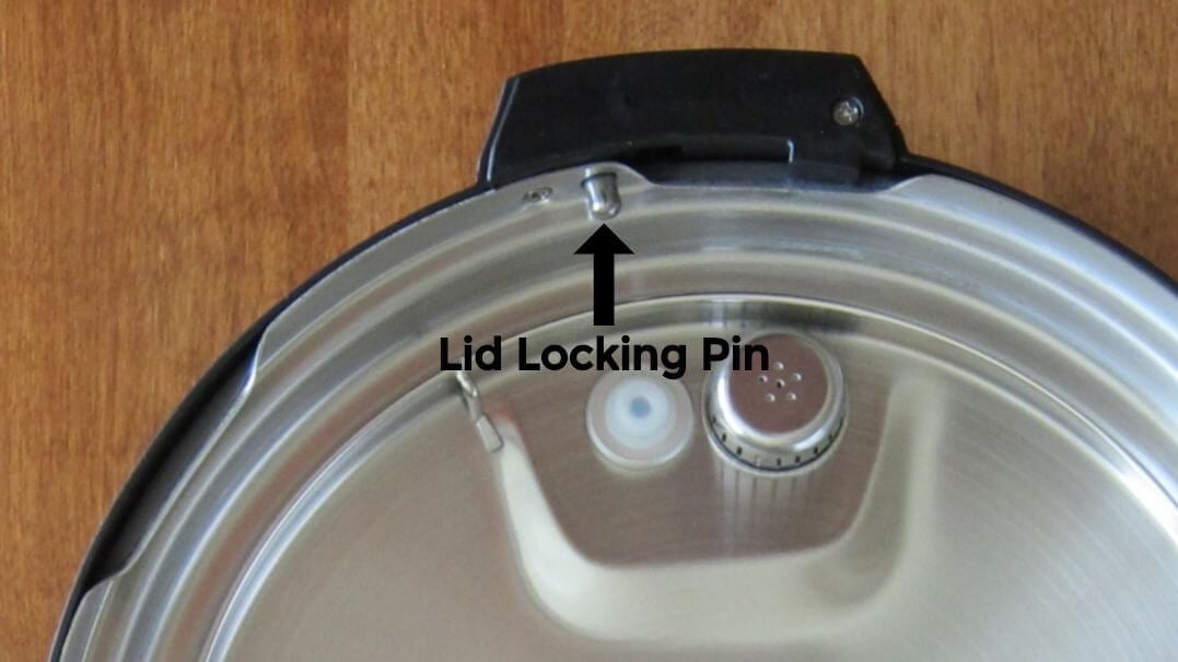 Instant Pot lid with arrow pointing to lid locking pin