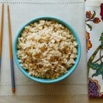 Instant Pot Brown Rice P1 turquoise bowl with brown rice with flowered napkin in background