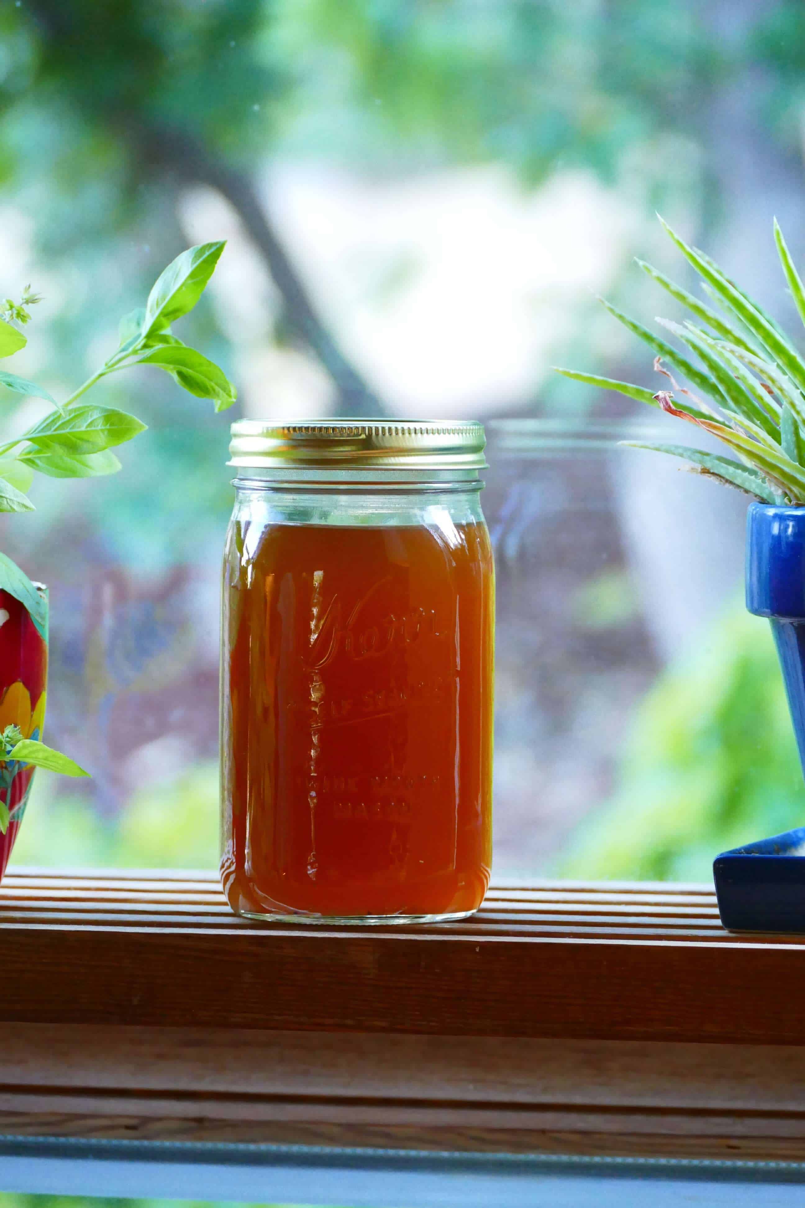 Instant Pot Seafood Stock in mason jar on a window sill