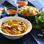 Instant Pot Thai Yellow Curry with Chicken in white bowl on blue napkin, with fried rice in another bowl