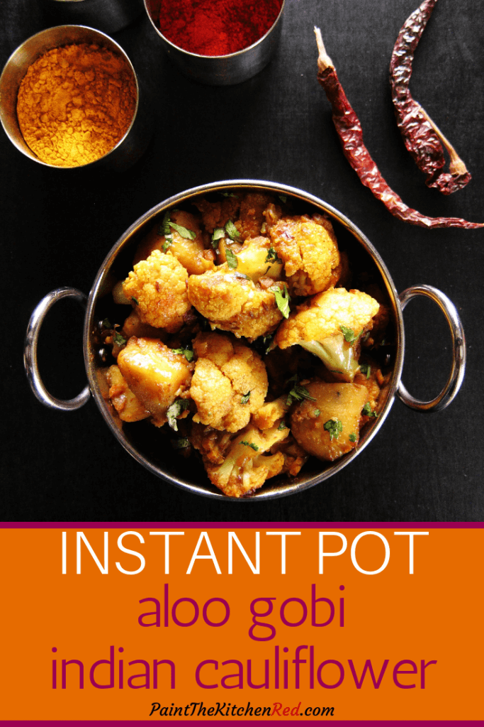 Instant Pot Aloo Gobi | Indian Cauliflower Pinterest pin - Cauliflower and potatoes with cilantro in metal bowl with bowls of Indian spices in the background - Paint the Kitchen Red