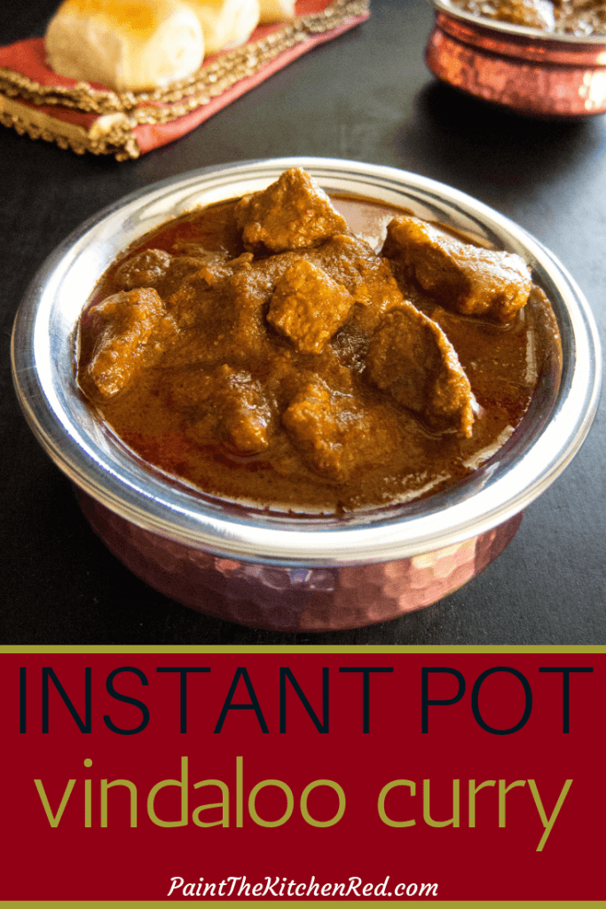 Instant Pot Vindaloo Pinterest pin - vindaloo curry in copper dish with bread and secon dish in background - Paint the Kitchen Red