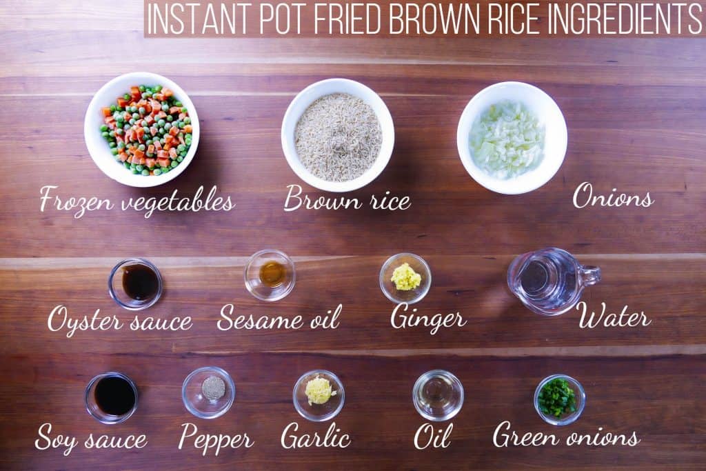 Instant Pot Brown Fried Rice Ingredients - frozen vegetables, brown rice, onions, oyster sauce, sesame oil, ginger, water, woy sauce, pepper, garlic, oil, green onions 