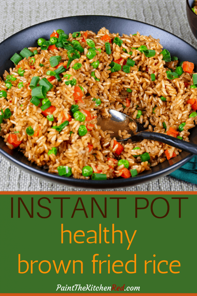 Instant Pot Brown Fried Rice Pinterest pin - black bowl with rice, peas, carrots, green onions and a serving spoon - Paint the Kitchen Red