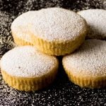 Instant Pot Cupcakes Cardamom Pound Cakes stacked on a black background and dusted with confectioners sugar - Paint the Kitchen Red