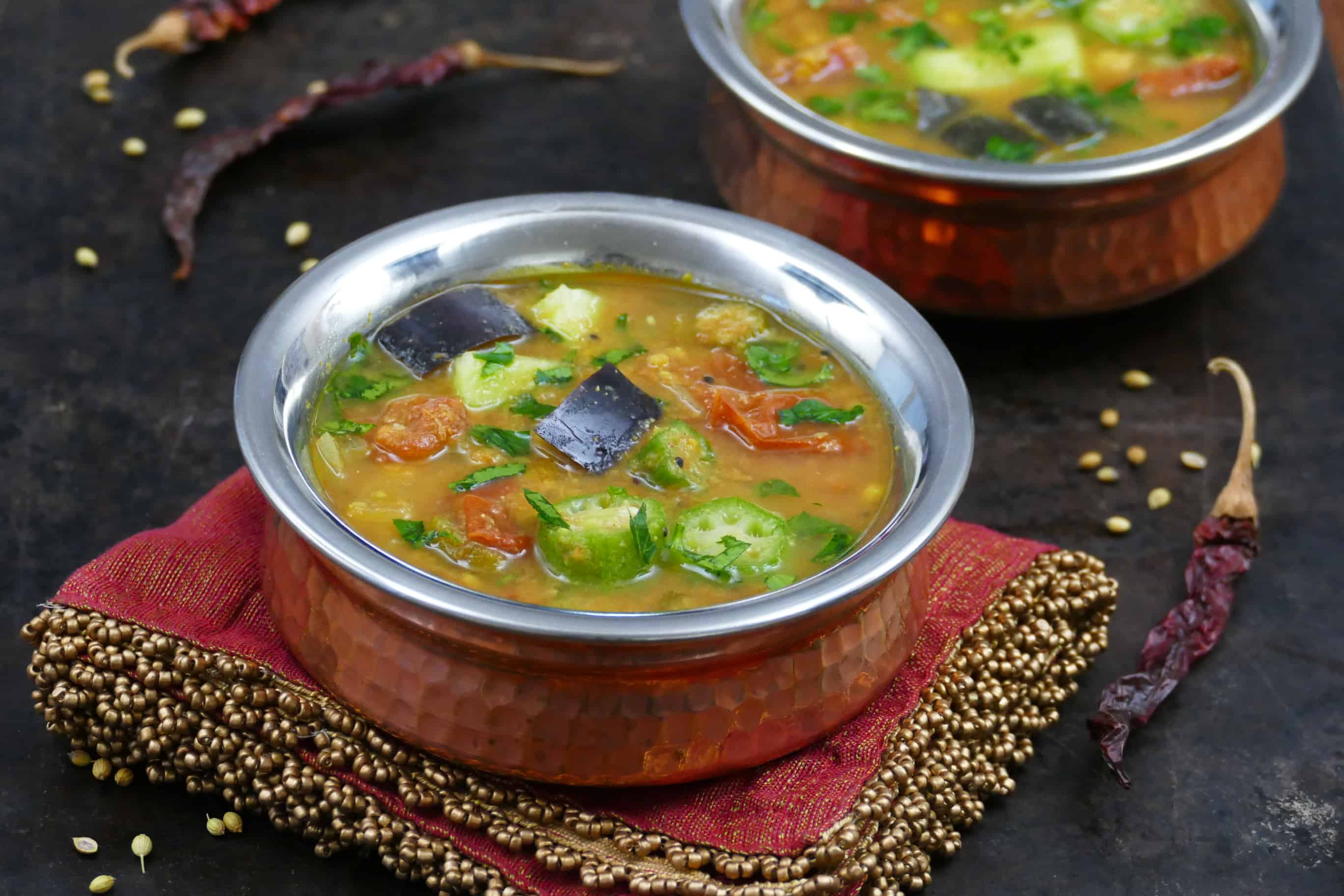 Instant Pot Sambar L1 - two bowls of sambar with tomatoes, eggplant okra, garnished with cilantro