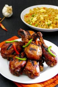 Instant Pot Korean Chicken - plate of grilled chicken with fried rice in background - Paint the Kitchen Red