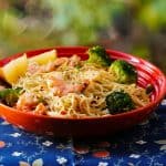 Instant Pot Shrimp Pasta with Garlic, parmesan, broccoli with lemon wedges in orange bowl - Paint the Kitchen Red