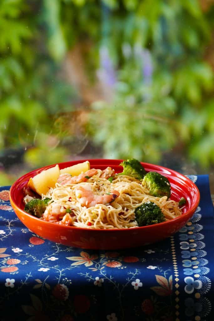 Instant Pot Shrimp Pasta with Garlic, parmesan, broccoli with lemon wedges in orange bowl - Paint the Kitchen Red