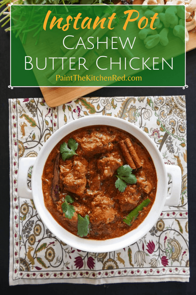 Instant Pot Cashew Butter Chicken Pinterest pin with chicken in white bowl on flowered napkin, with cinnamon, cilantro, cashews in background - Paint the Kitchen Red