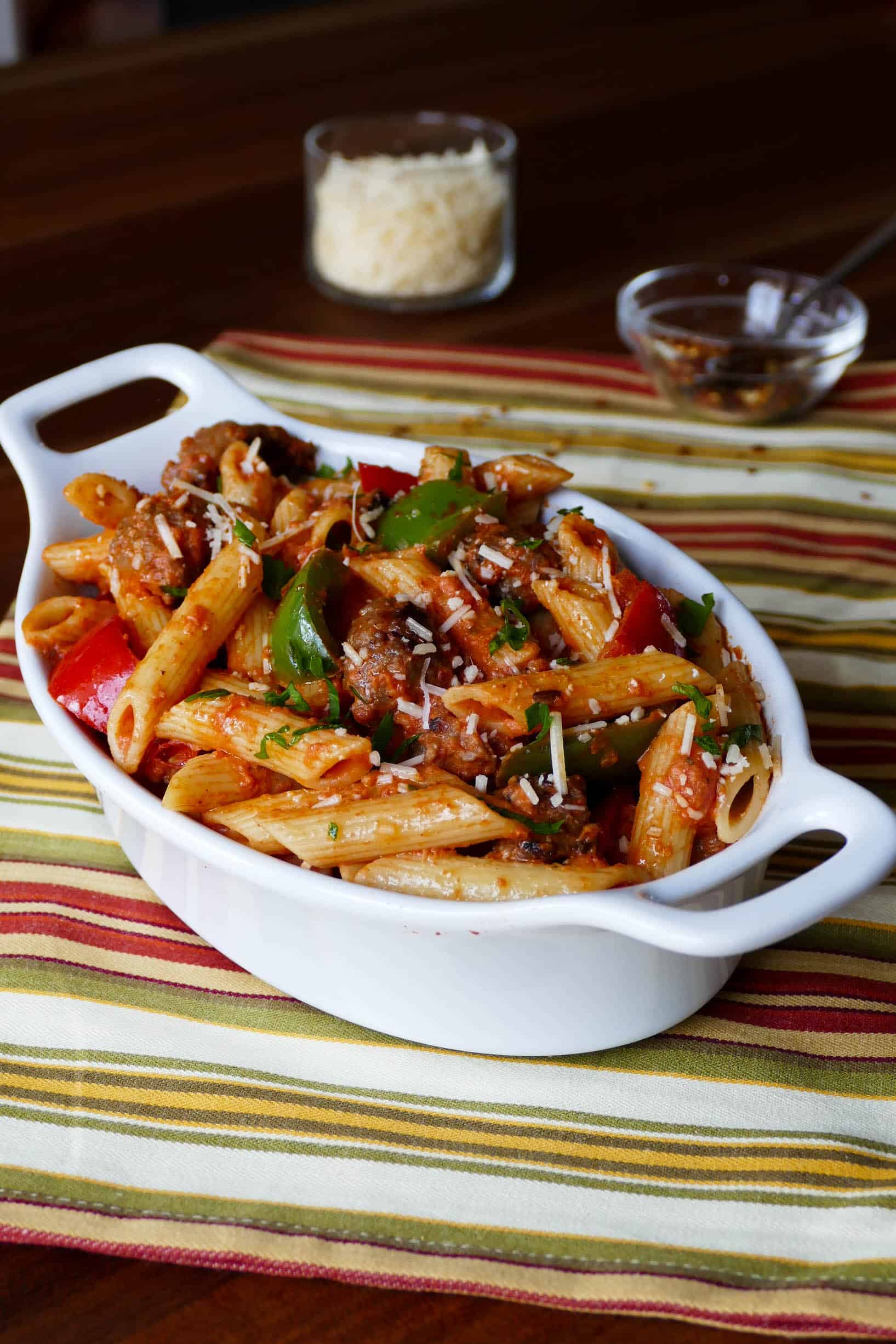 Instant Pot Pasta - Penne Sausage with Tomato Cream sauce in a white oval serving bowl- Paint the Kitchen Red