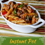 Instant Pot Pasta - Penne Sausage with Tomato Cream sauce in a white oval serving bowl- Paint the Kitchen Red