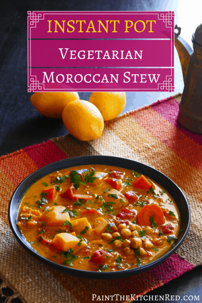 Vegetarian Instant Pot Moroccan Stew Pinterest image - stew with carrots, squash, chickpeas, cilantro, tomatoes in black bowl on colorful mat with lemons in background