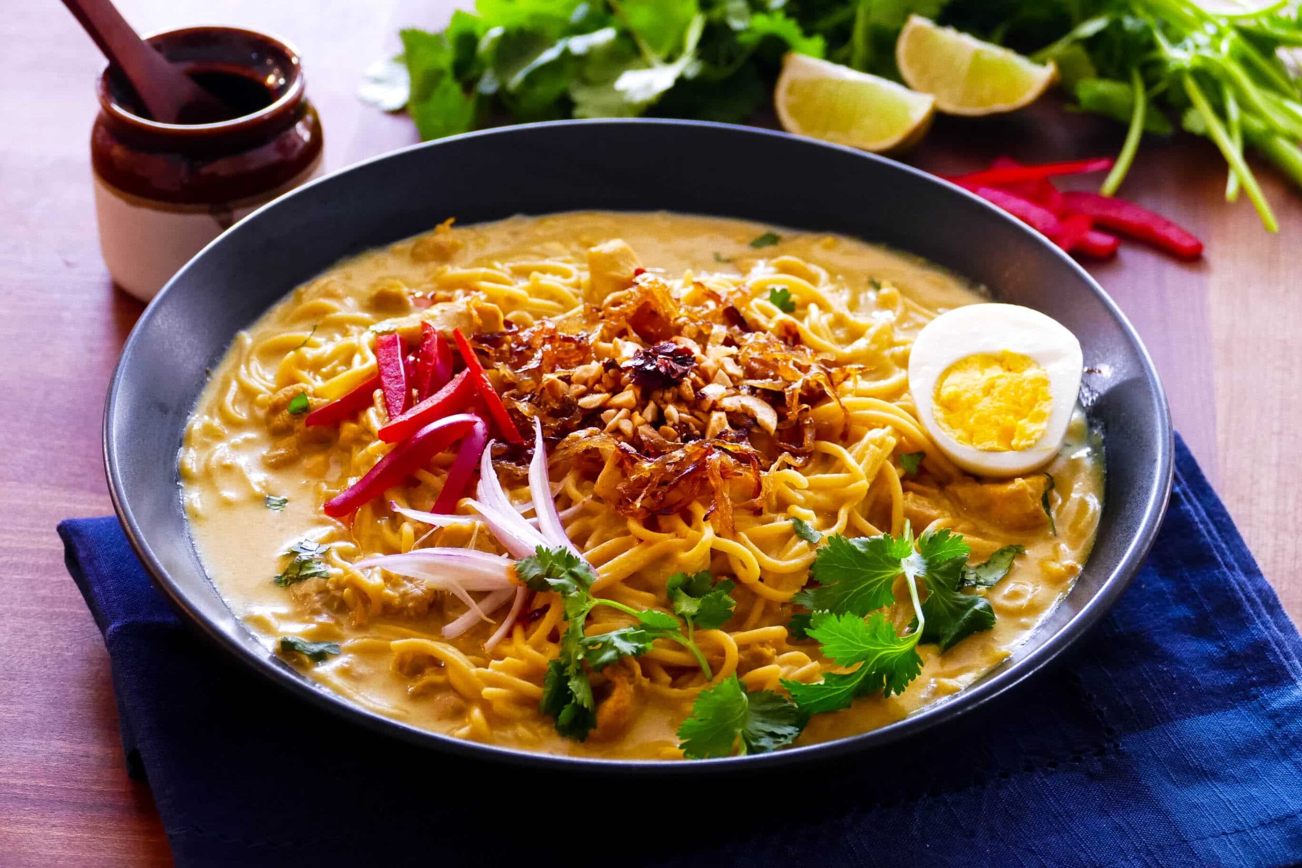 Instant Pot Khao Suey - Burmese noodles in coconut curry broth topped with fried onions, garlic, boiled egg and cilantro