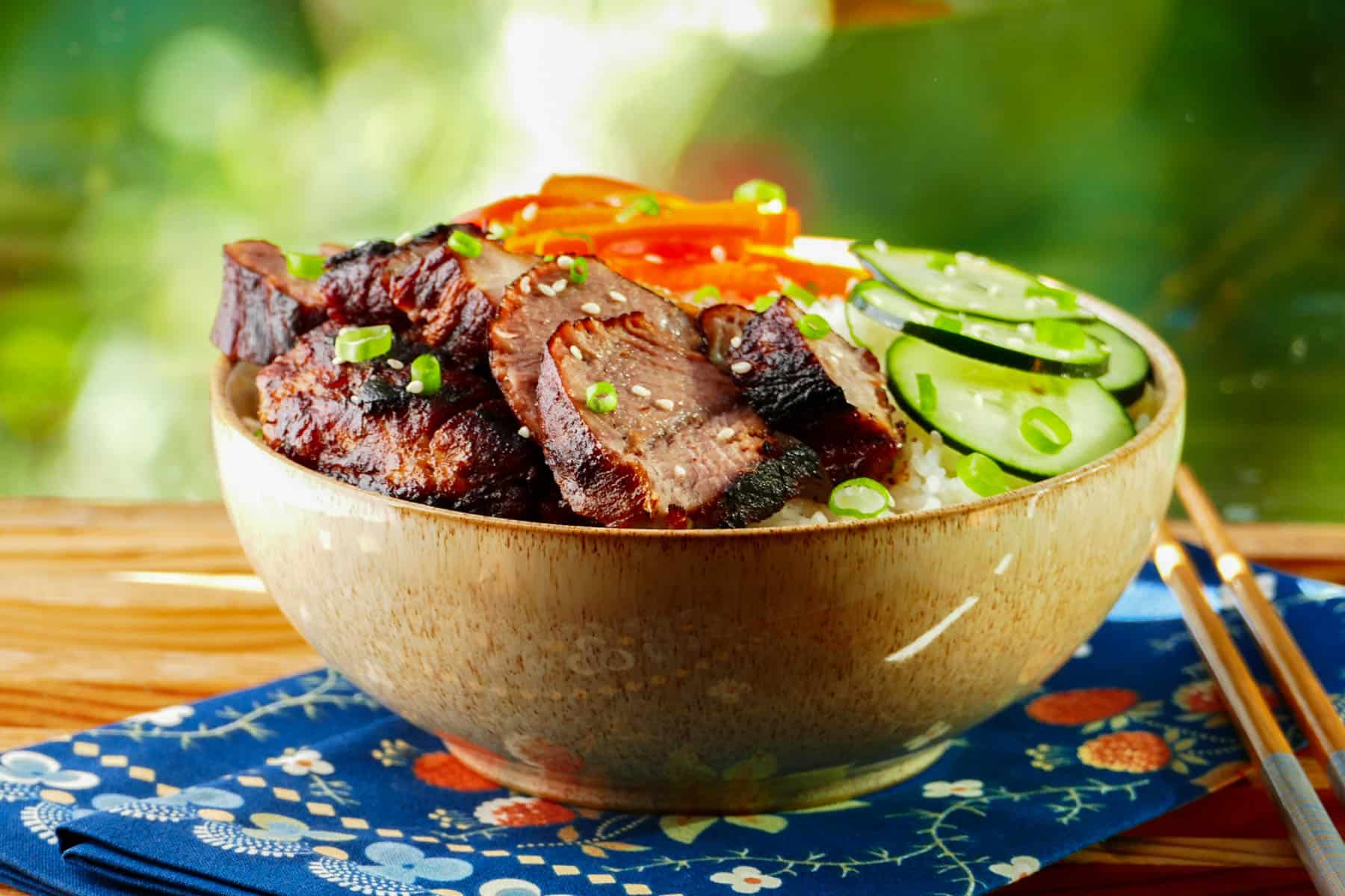 Instant Pot Char Siu - Chinese bbq pork in a bowl with rice, cucumbers and bell peppers