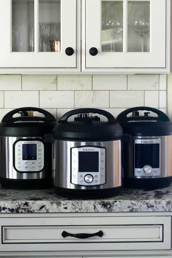 Three Instant Pots side by side on countertop