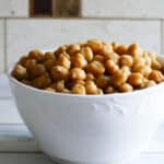 A bowl of cooked chickpeas on a white counter