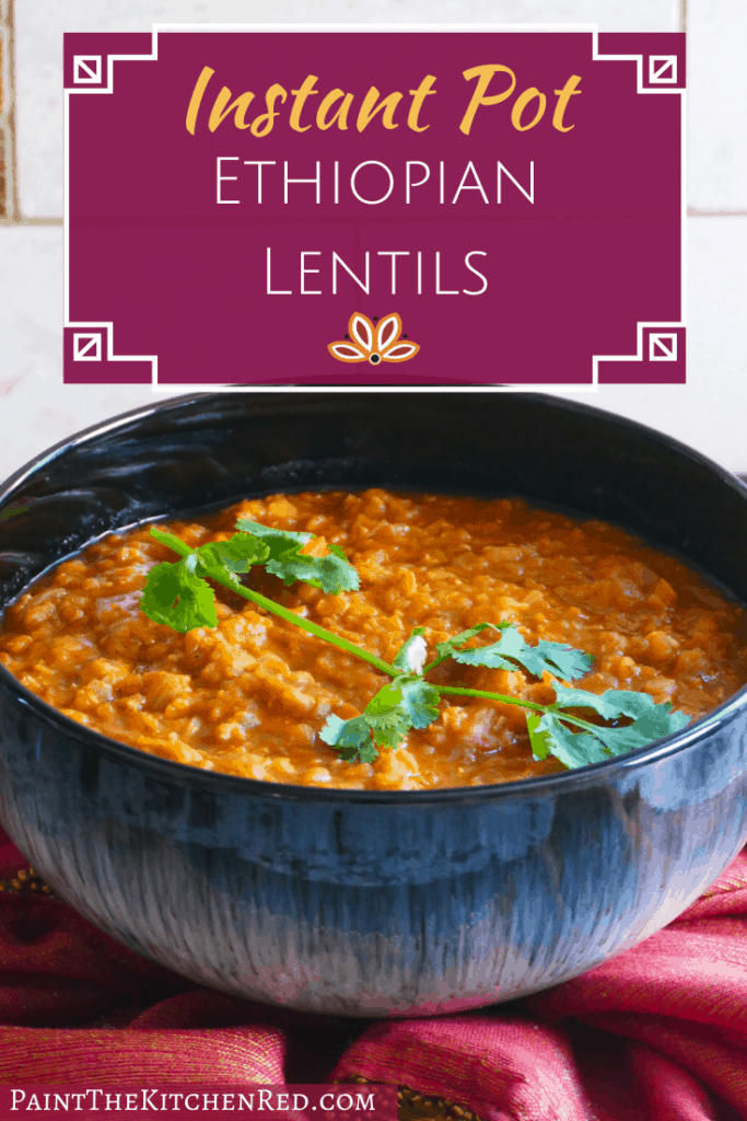 Blue bowl of orange red Ethiopian lentils garnished with cilantro on a red and gold napkin - Pinterest pin