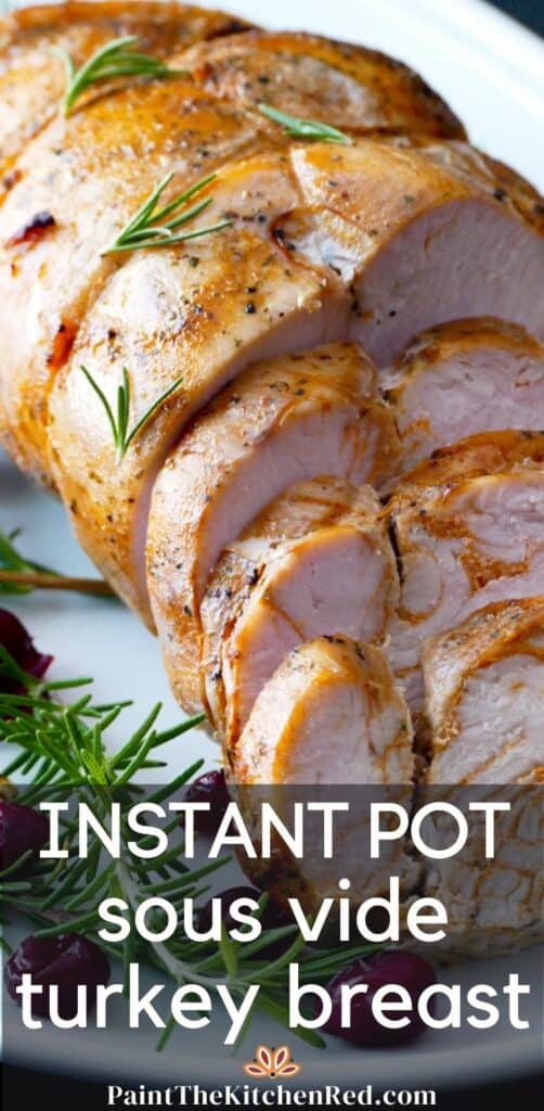 Instant pot sous vide turkey breast - partly sliced on a white platter with rosemary and cranberry garnish