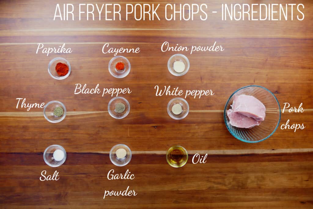 Air fryer pork chops - ingredients - paprika, cayenne, onion powder, thyme, black pepper, white pepper, pork chops, salt, garlic powder, oil