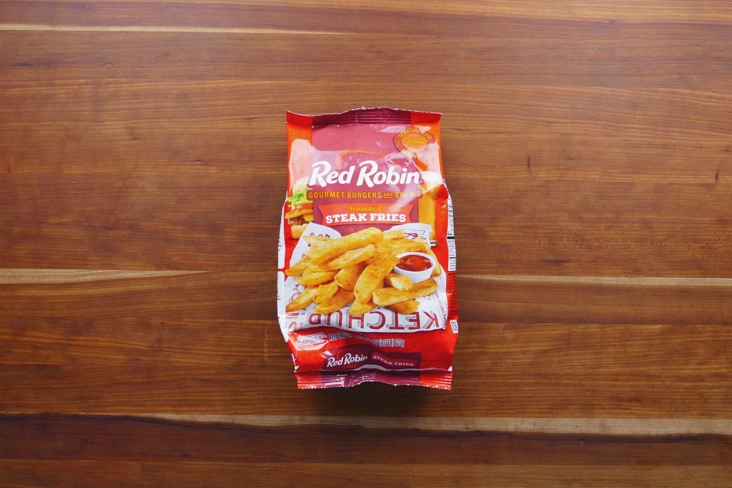 Bag of Red Robin steak fries on wooden surface