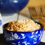blue floral bowl with parboiled rice on blue napkin