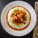 Instant Pot Shrimp and Grits garnished with green onions on a white plate