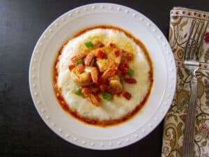 Instant Pot Shrimp and Grits garnished with green onions on a white plate