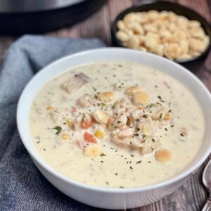 white bowl with creamy chowder and seafood pieces