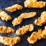 chicken tenders arranged on dark background