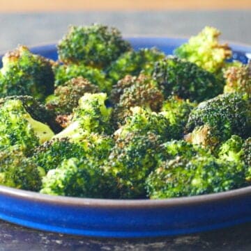 Blue plate with roasted broccoli laid out.