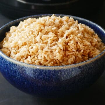 Heaping mound of brown rice in a blue bowl