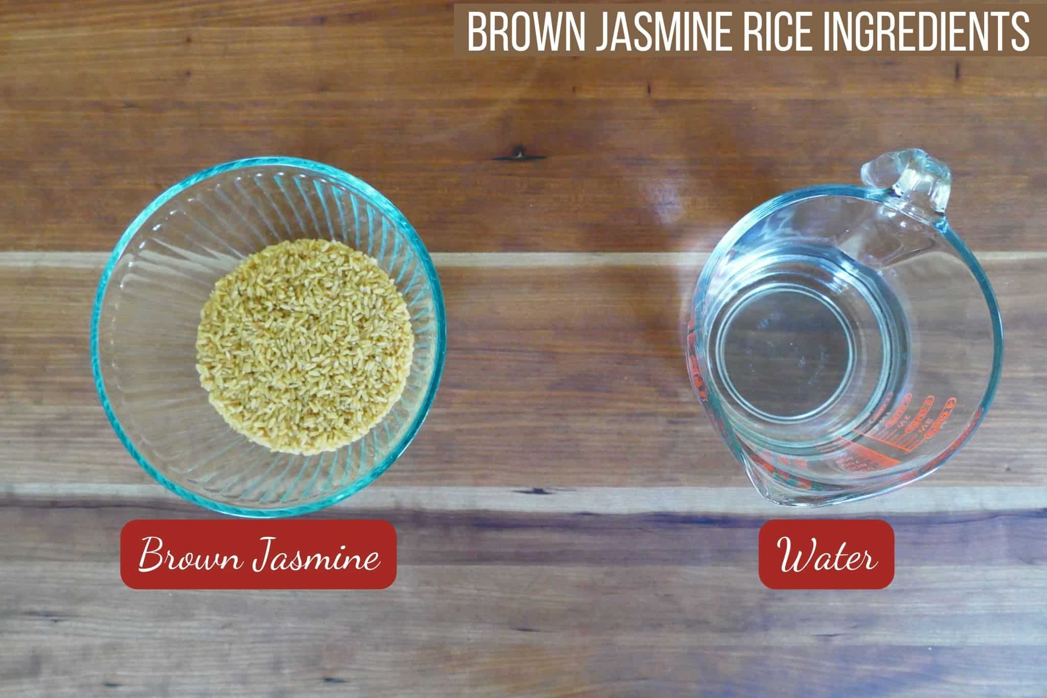 brown rice in bowl and water in measuring cup on a wooden countertop