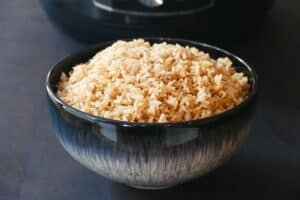 Instant Pot Jasmine Rice - A heaping mound of brown rice in a blue bowl