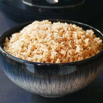 Instant Pot Jasmine Rice - A heaping mound of brown rice in a blue bowl